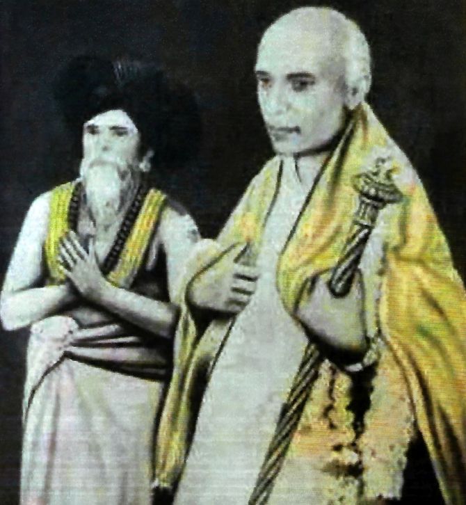 Pt. Nehru holding 'Sengol' with Kumaraswamy Thambiran